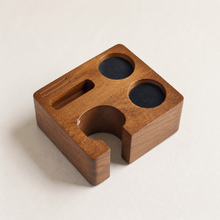 58 mm solid wood espresso tamping station on a warm studio background