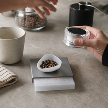 Silver mini coffee scale set used in a home coffee ritual